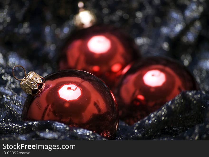 Red Christmas balls on the sheer black material. Red Christmas balls on the sheer black material