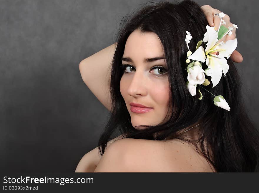 Beautiful woman with a flower in hairs