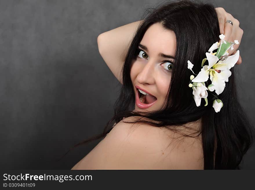 Beautiful woman with a flower in hairs