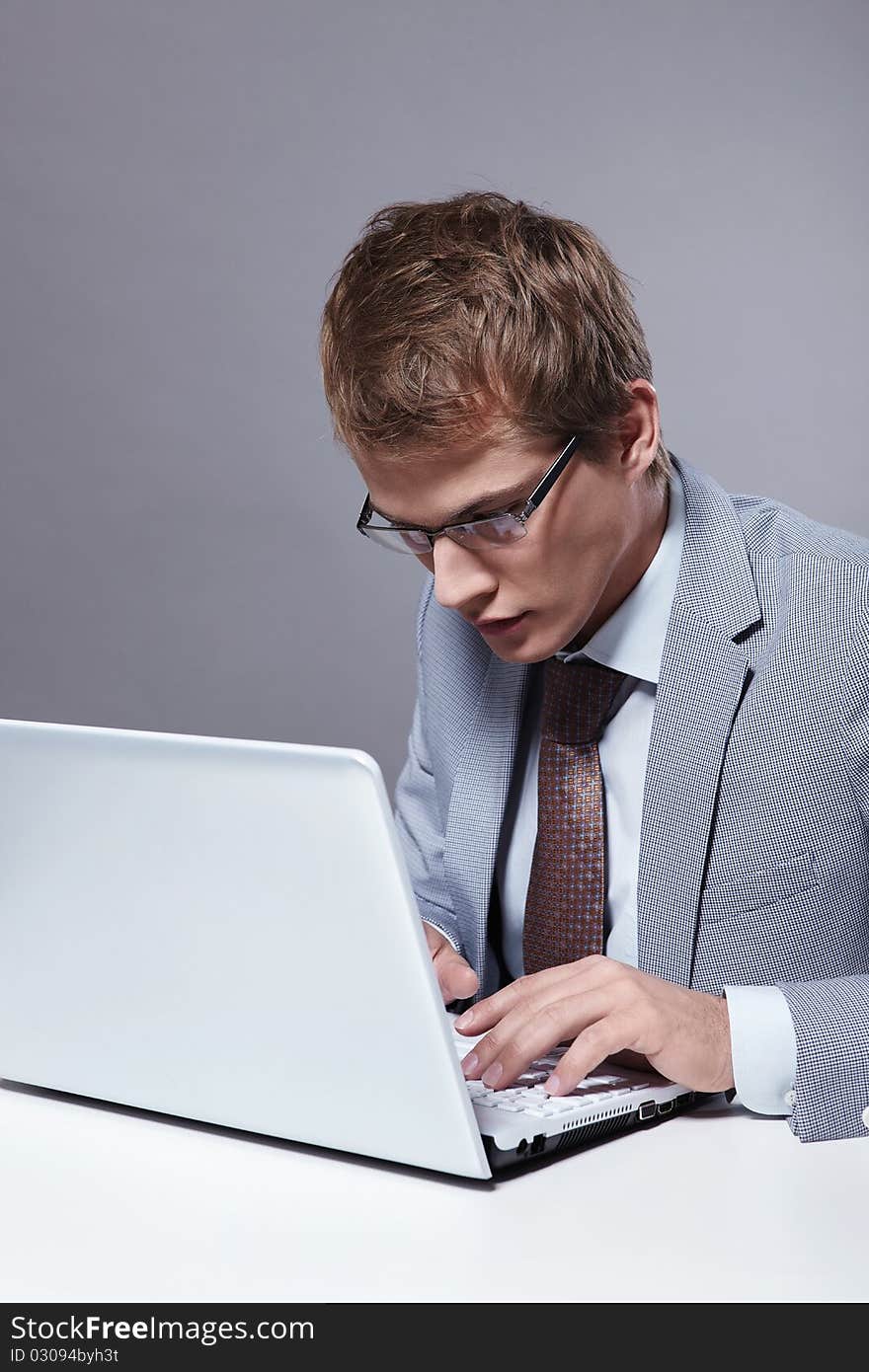 Young businessman working with laptop. Young businessman working with laptop