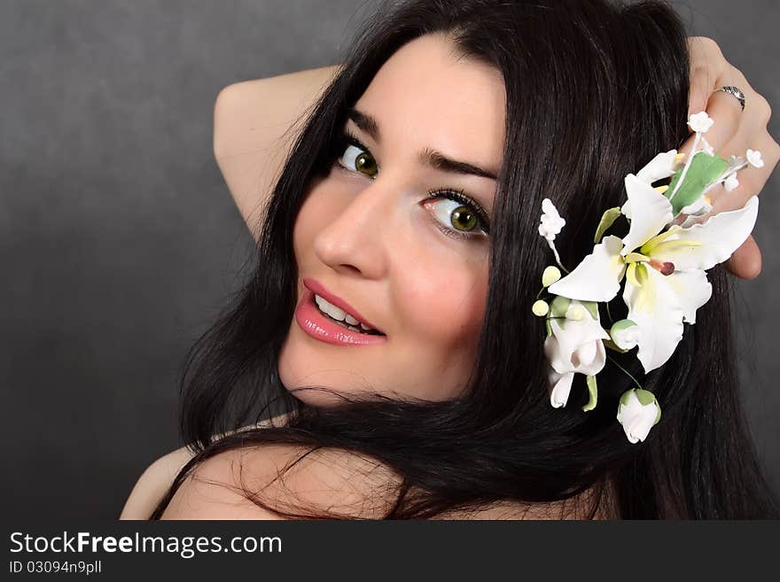 Beautiful woman with a flower in hairs