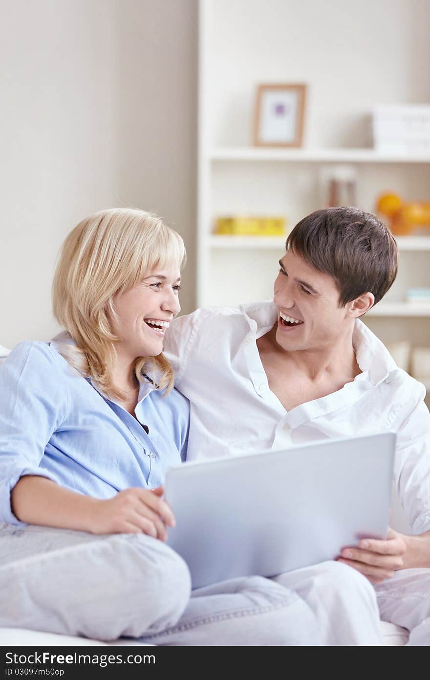 Happy young couple with laptop. Happy young couple with laptop