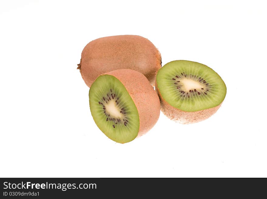 Two kiwi fruit on white background. One of the fruit is cut into two parts. Two kiwi fruit on white background. One of the fruit is cut into two parts.