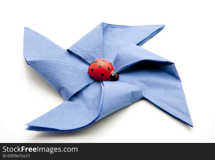 Folded blue napkin and onto white background. Folded blue napkin and onto white background