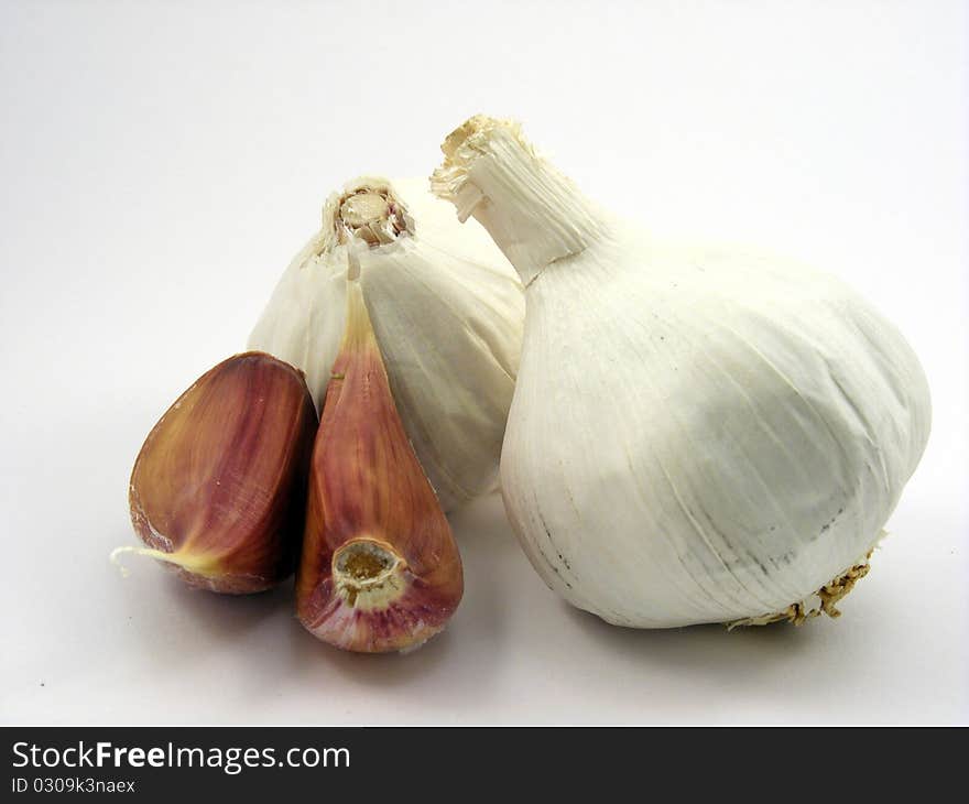 A selection of different pieces of garlic on a white background. A selection of different pieces of garlic on a white background