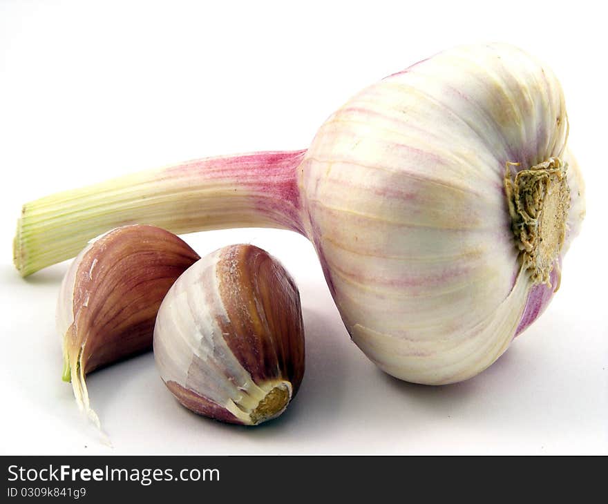 A selection of different pieces of garlic on a white background. A selection of different pieces of garlic on a white background