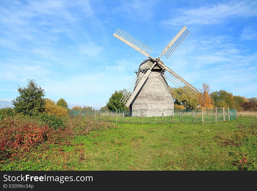 Aging wooden mill on a celestial background