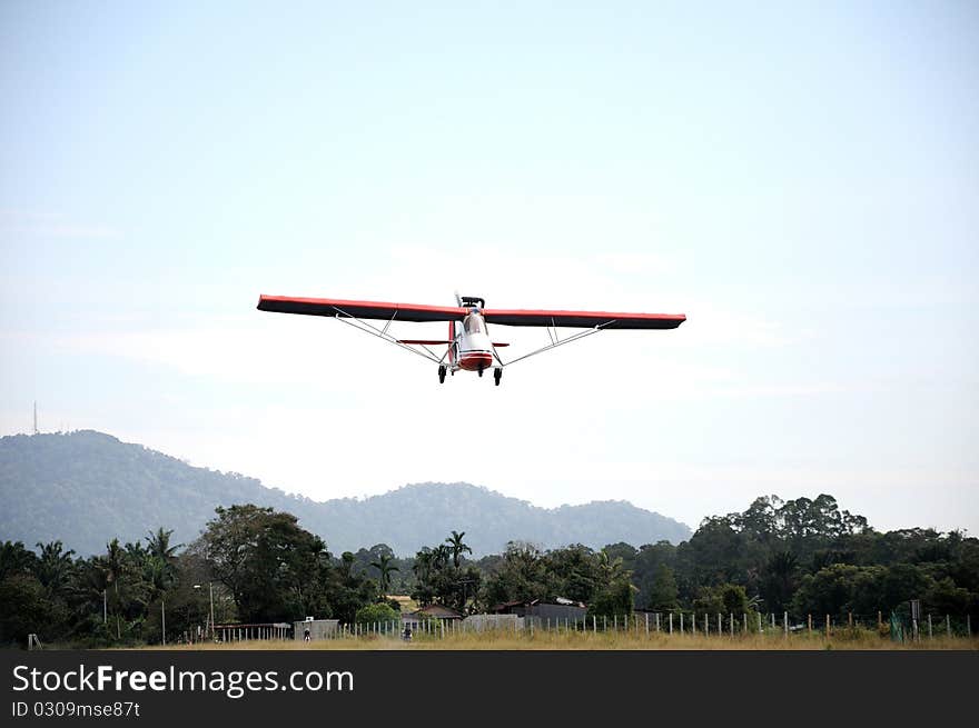 Small single seat plane prepare for landing. Small single seat plane prepare for landing