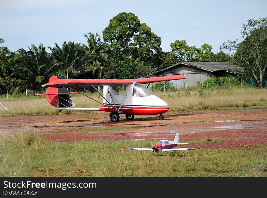 Real single seat plane with blurred RC plane in fore ground. Real single seat plane with blurred RC plane in fore ground