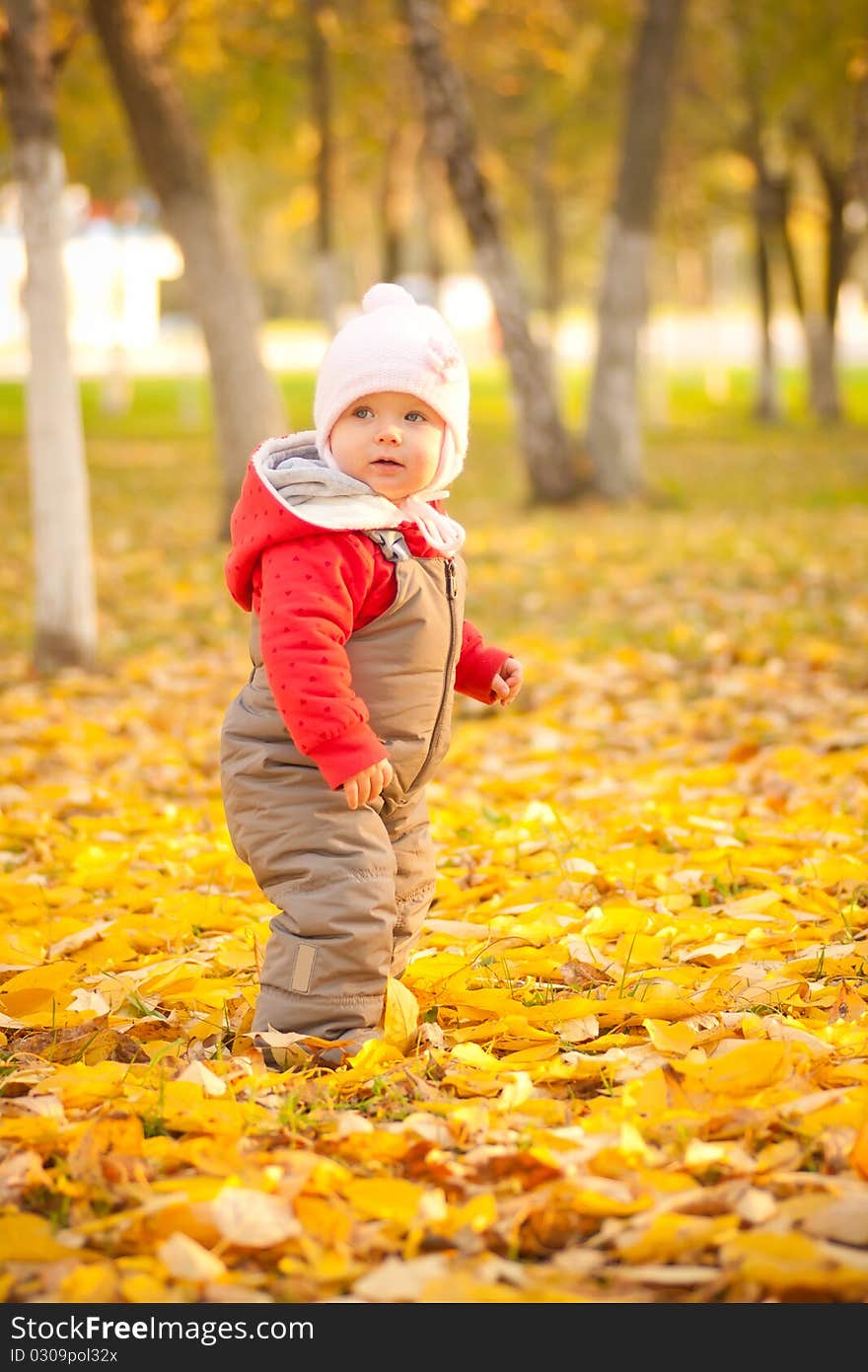 Cute baby walking in park near trees