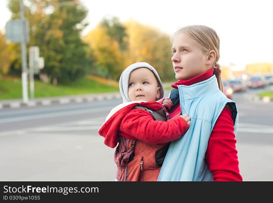 Mother With Baby Stay On Crossroad