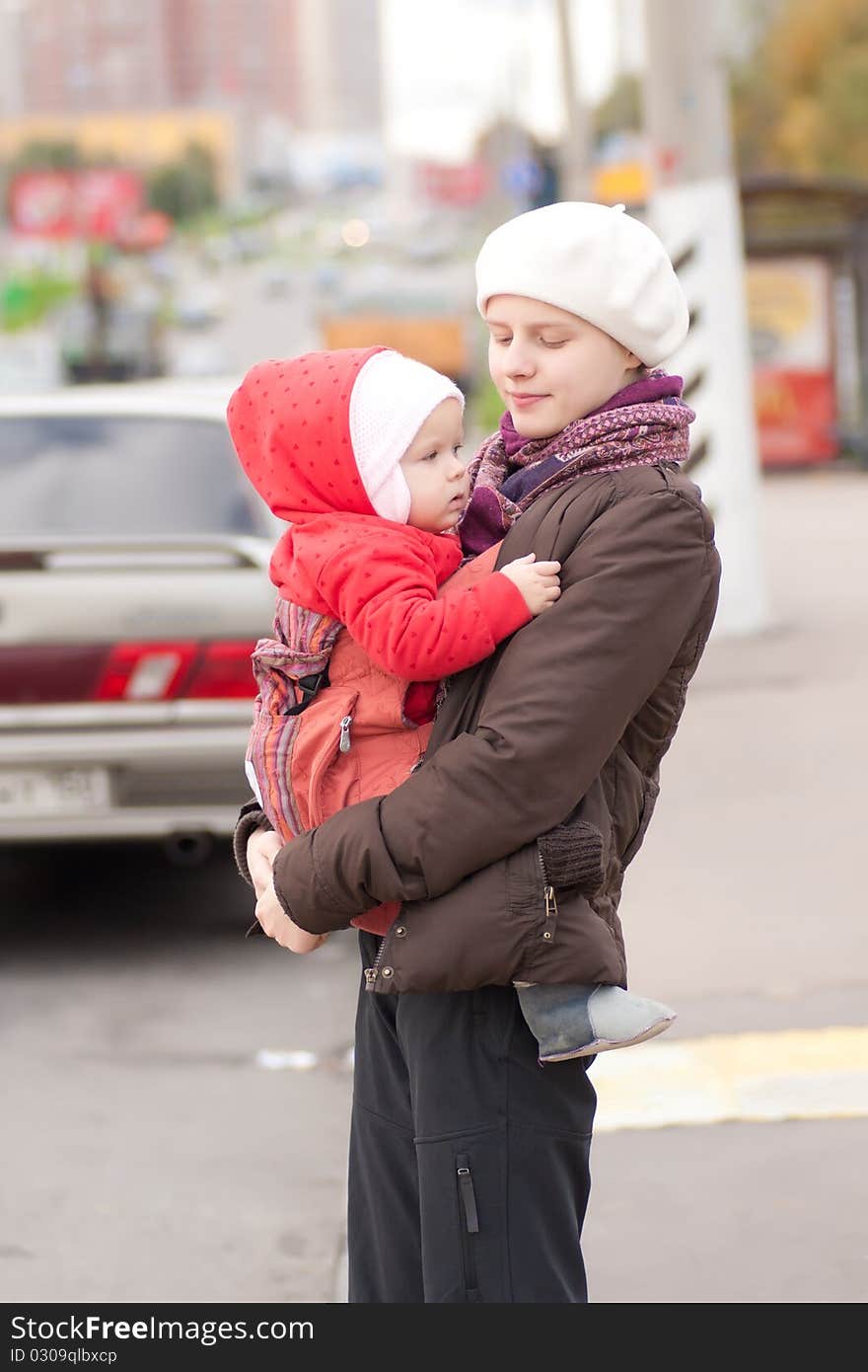 Young adorable mother and toddler girl stay on crossroad