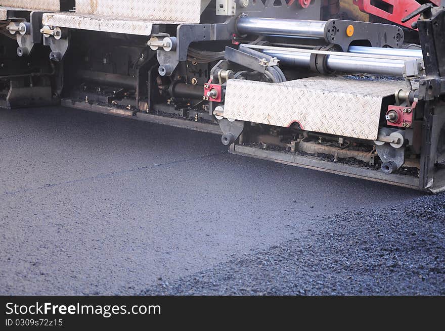 Large stones pressed hot asphalt. Large stones pressed hot asphalt