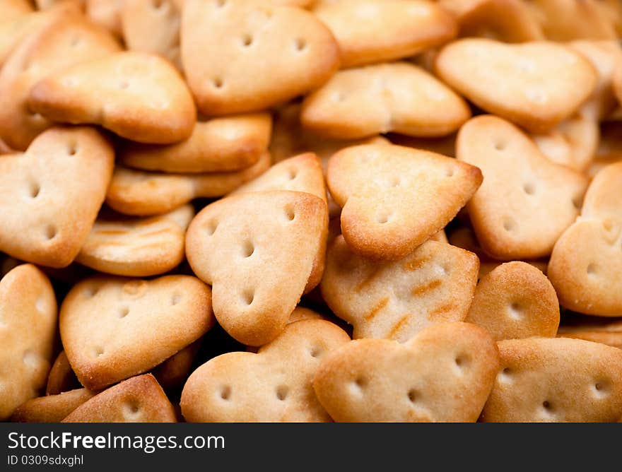 Background of salted heart shaped crackers. Background of salted heart shaped crackers