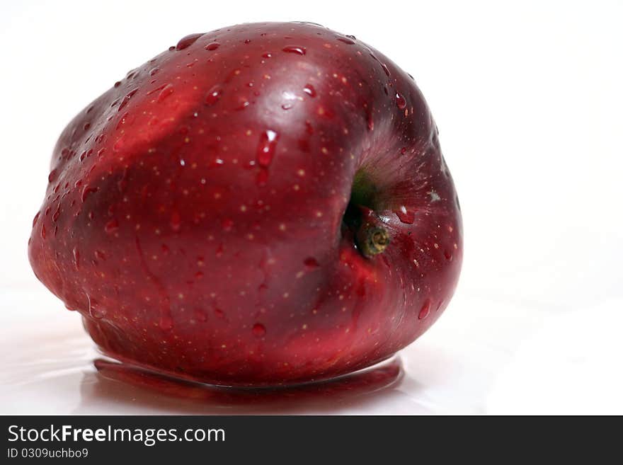 Red apple in water isolated on white