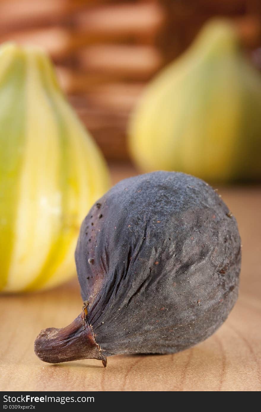 Ripe fruits of a fig on a wooden table.