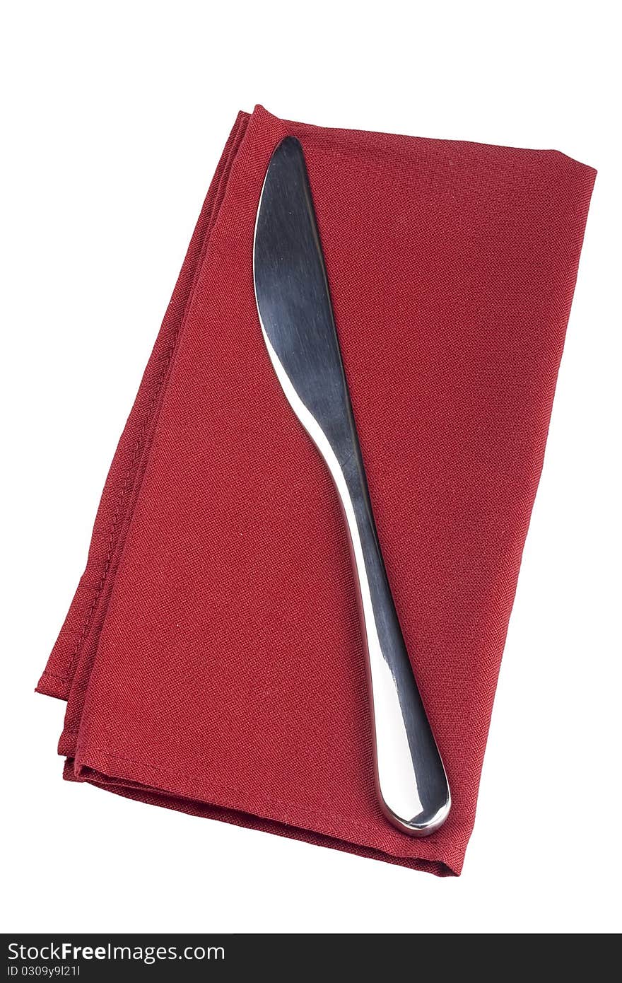 Table knife on a red cloth, tissue.