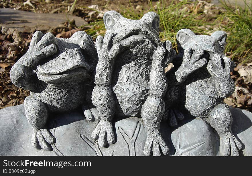 Whimsical garden frogs displaying classic aphorism. Whimsical garden frogs displaying classic aphorism