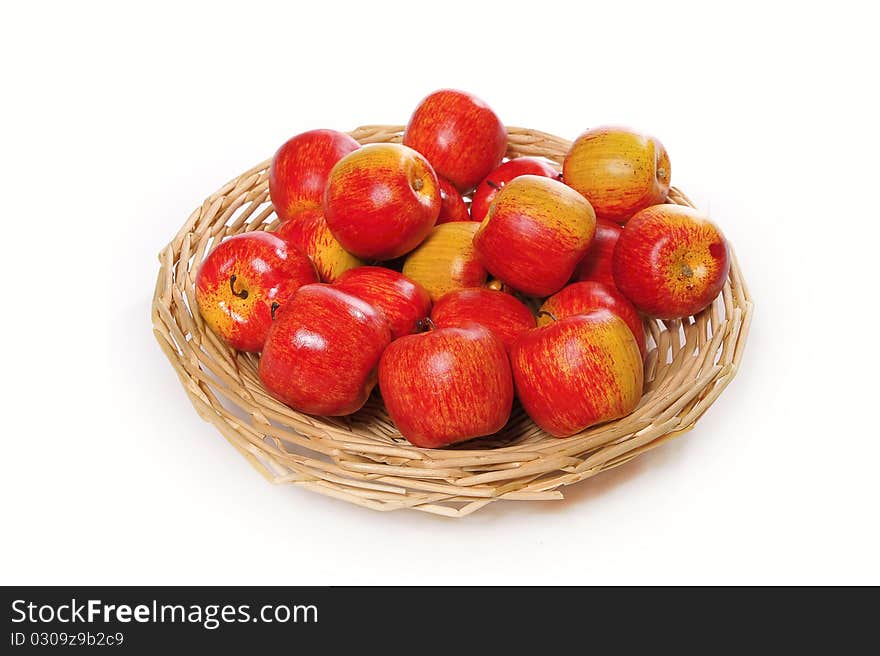 Apples on handbasket isolated on a white background