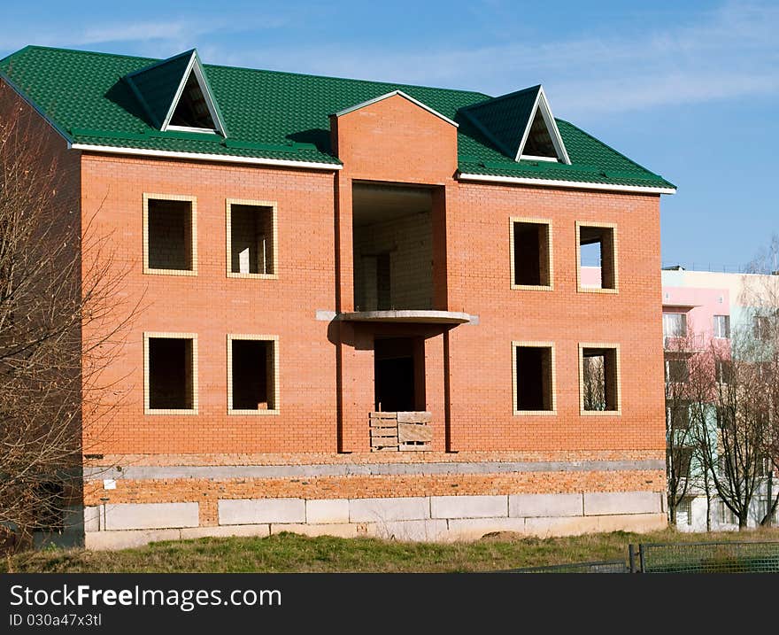 Construction of buildings of brick against the blue sky. Construction of buildings of brick against the blue sky