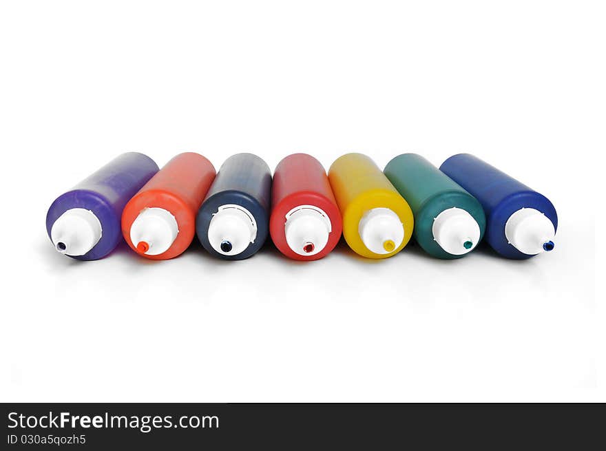 Group of seven multicolored color tubes on white background. Group of seven multicolored color tubes on white background