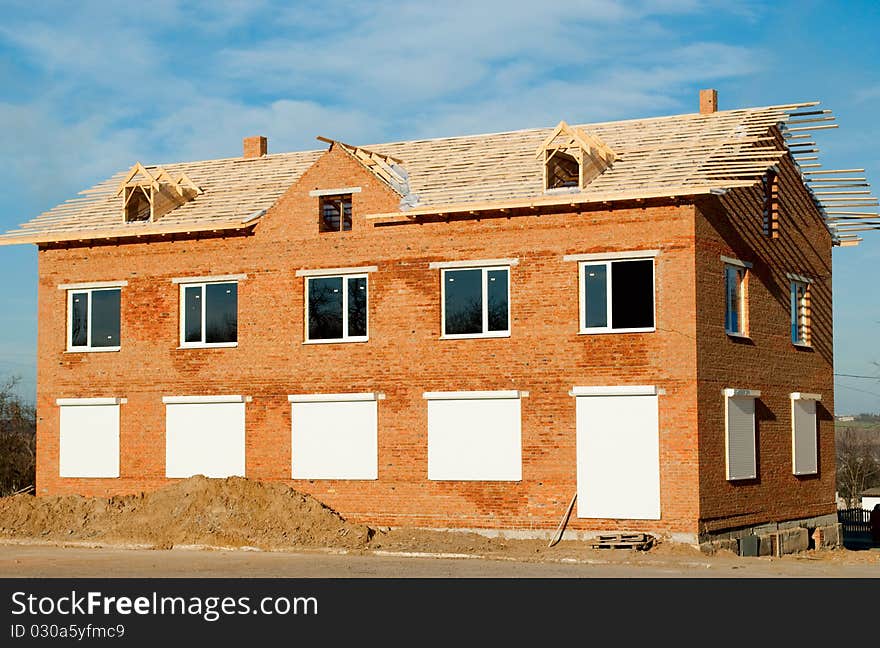 Construction of buildings of brick against the blue sky. Construction of buildings of brick against the blue sky