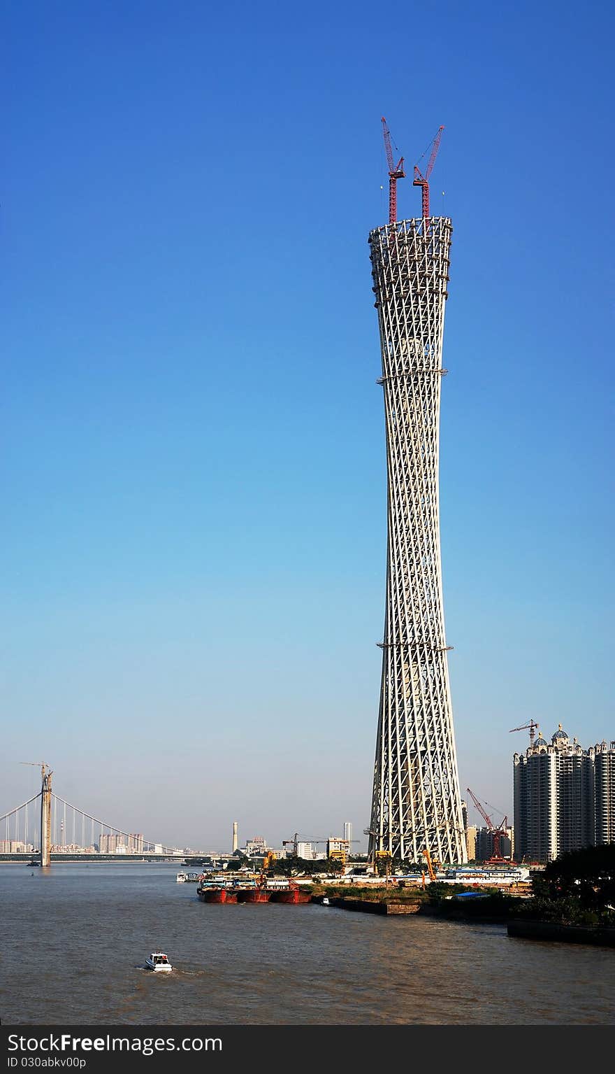 Canton tower under construction with blue sky in guangzhou city.