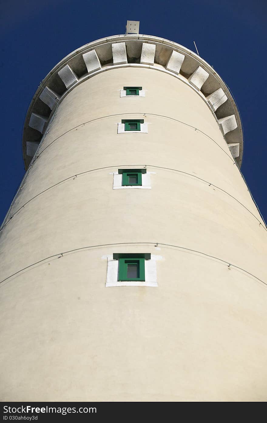 Lighthouse from below, blue sky in background