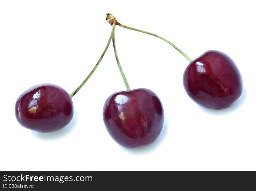 Three fresh sweet cherries on a white background. Three fresh sweet cherries on a white background