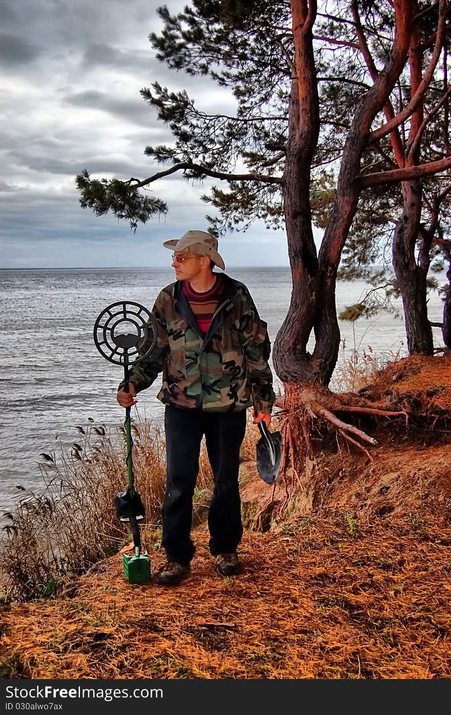 Military archeology. Man with metal detector on the battlefield of WW2.Ukraine