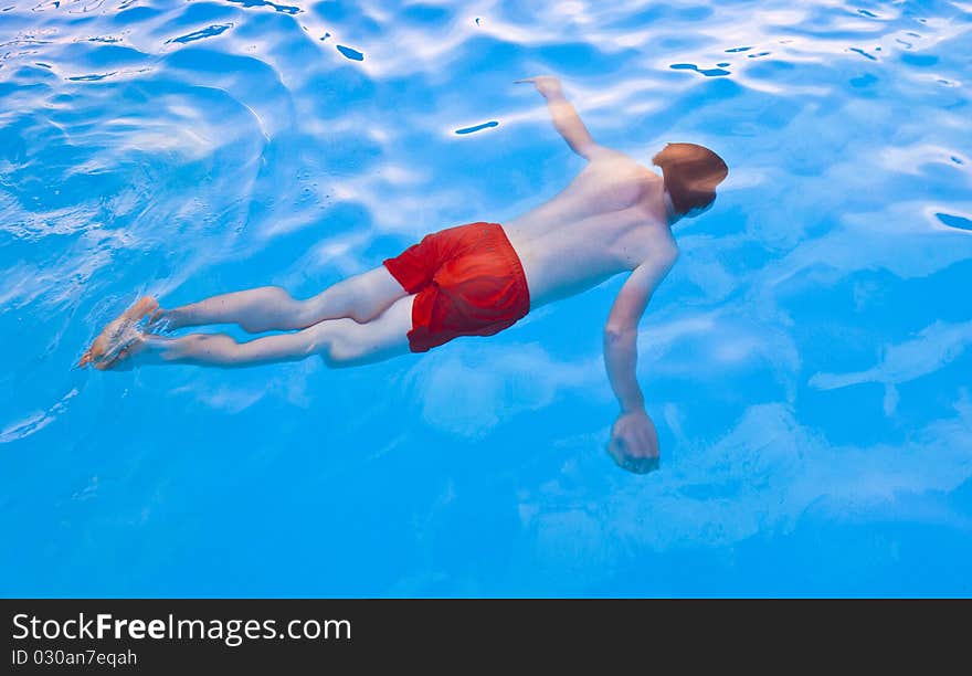 Boy has fun diving in the pool. Boy has fun diving in the pool