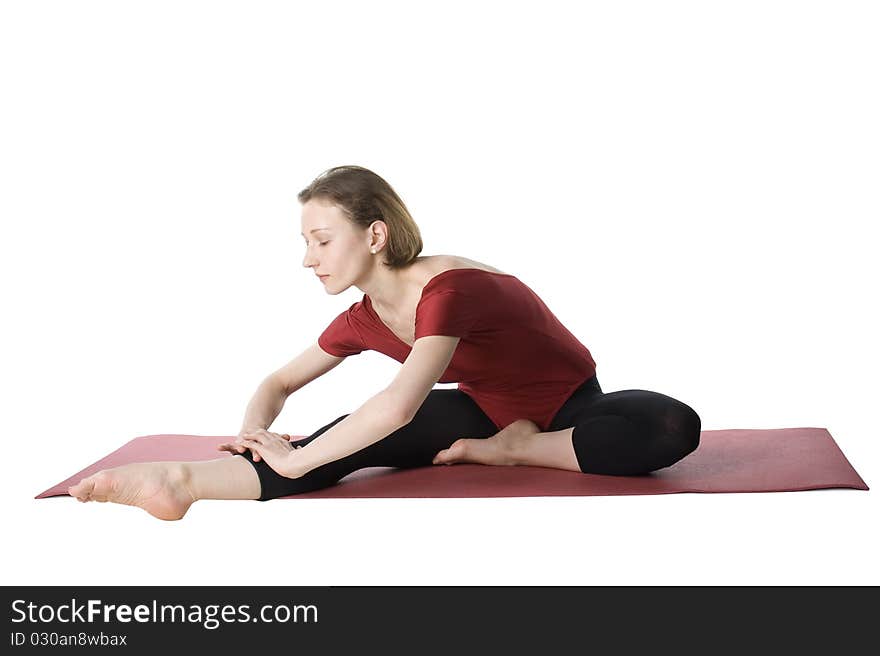 Woman exercising on a mat over white background. Woman exercising on a mat over white background