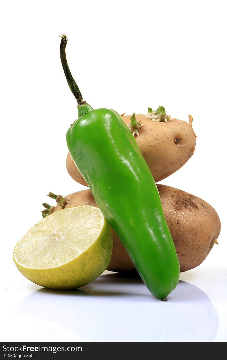 Food ingredients green chilly, potatoes and lemon isolated on white background.