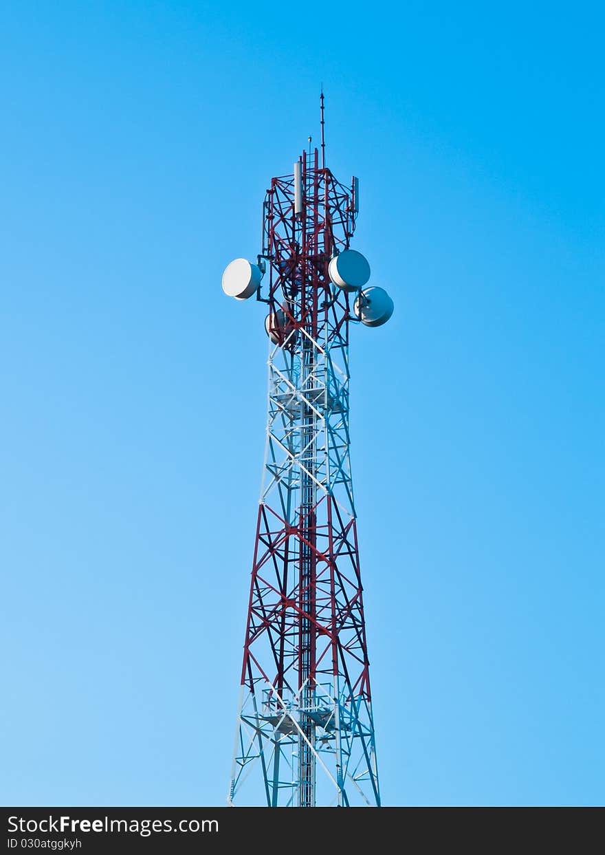 Mobile phone communication repeater antenna tower in blue sky