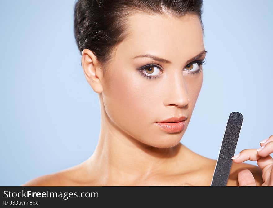 Portrait of beautiful woman, she doing her fingernails. Portrait of beautiful woman, she doing her fingernails