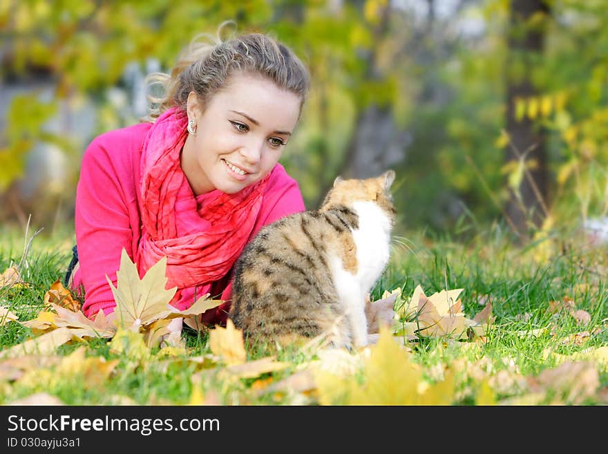 Attractive girl and cat on nature