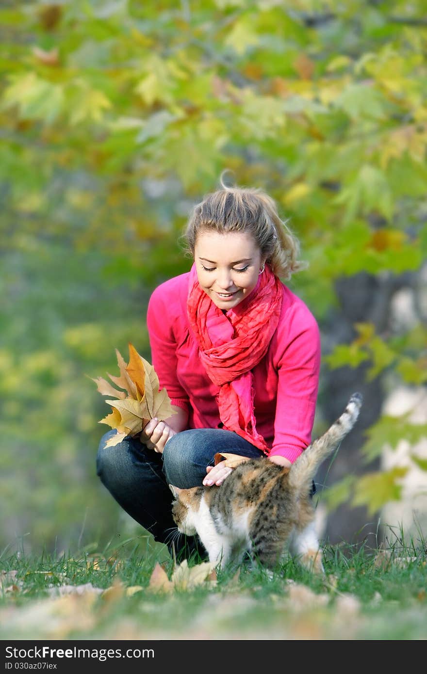 Attractive girl and cat on nature