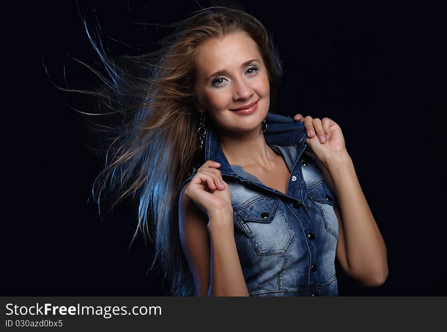 Portrait of a young woman on a dark background