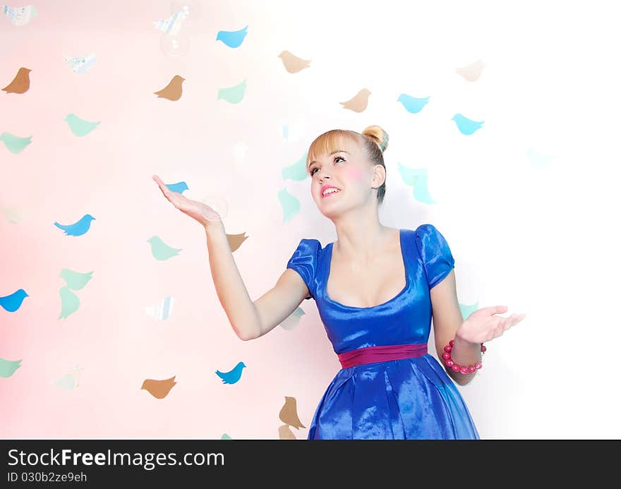 Studio portrait of young happy girl on fantasy background