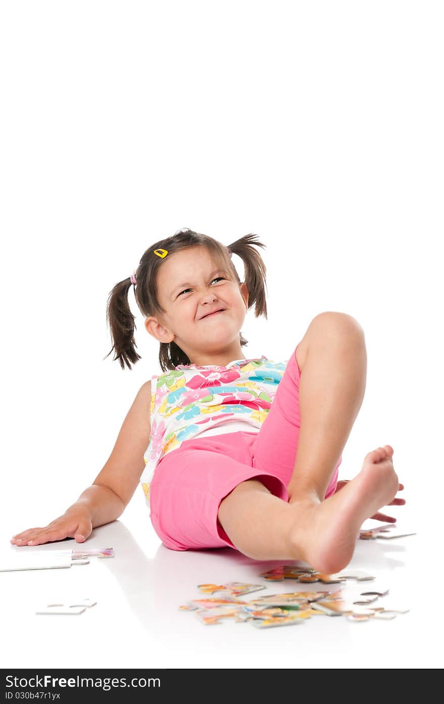 Little girl grimacing over white background