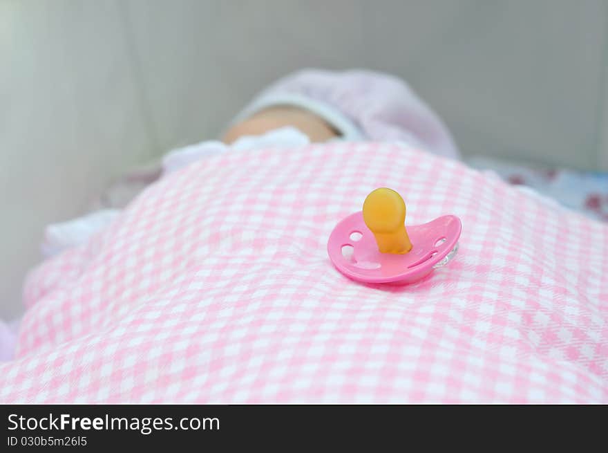 Soother on the background of a newborn