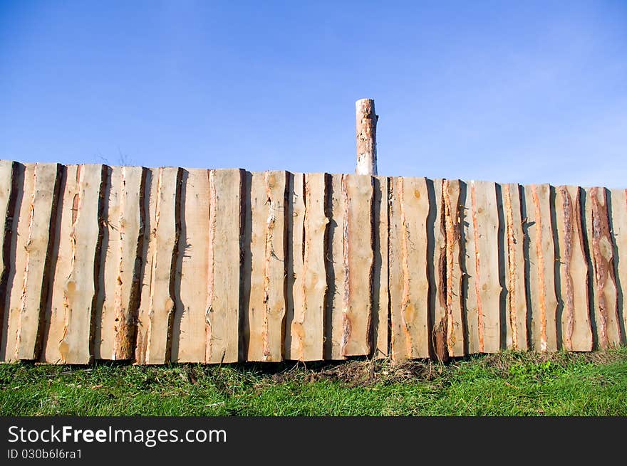 Wooden fence against blue sky. Wooden fence against blue sky