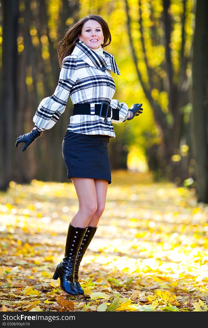 Beautiful girl with long hair jumping in a park. Beautiful girl with long hair jumping in a park