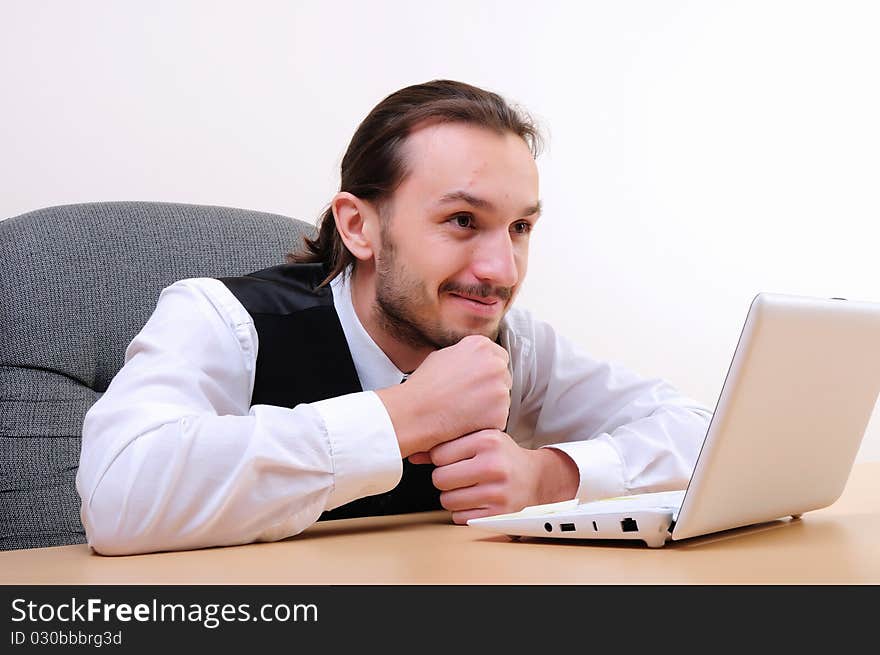 A young business man working on the computer in the office.