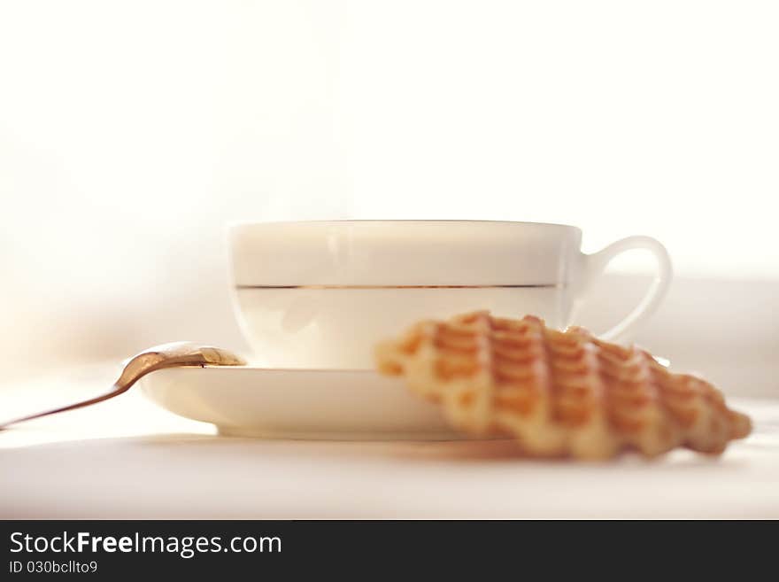 Hot coffee with wafers, close-up