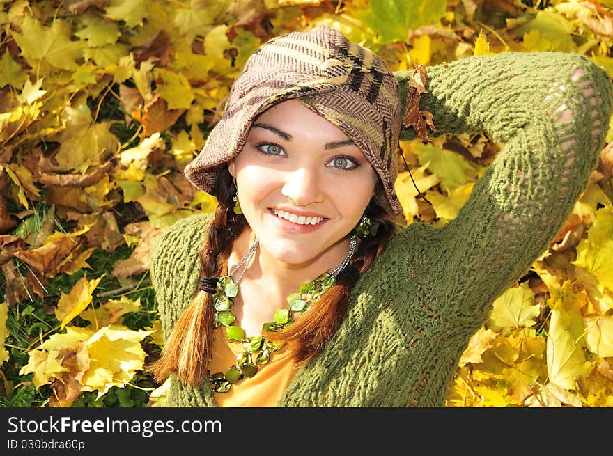 Woman in yellow autumn leaves