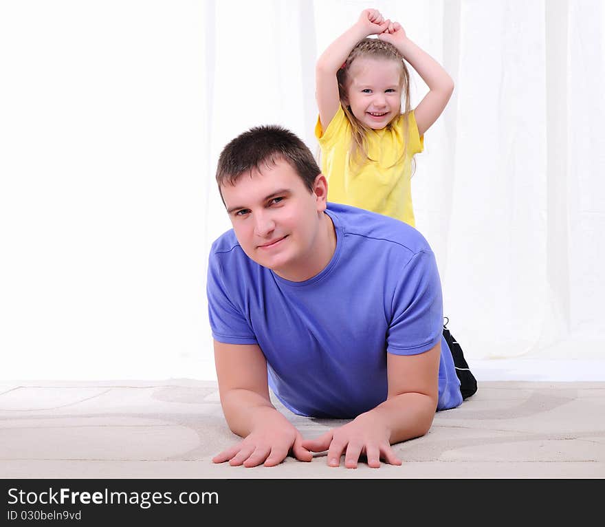 A young father has fun with his daughter