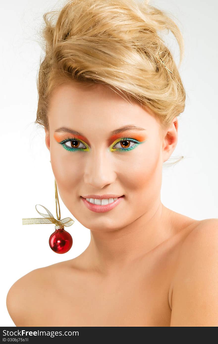 Amazing smiling young woman with earring from xmas ball. Amazing smiling young woman with earring from xmas ball