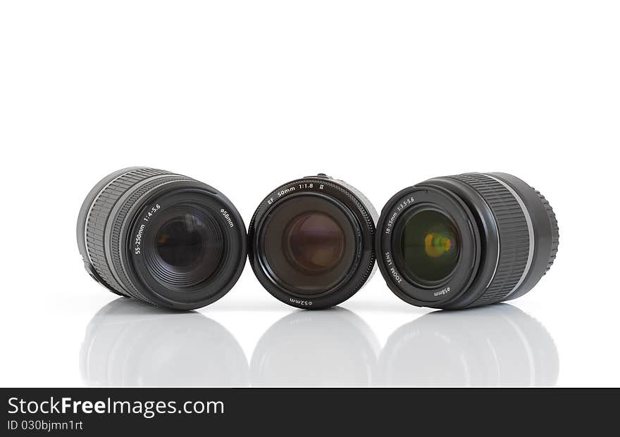 A set of three lenses for DSLR camera on a white background