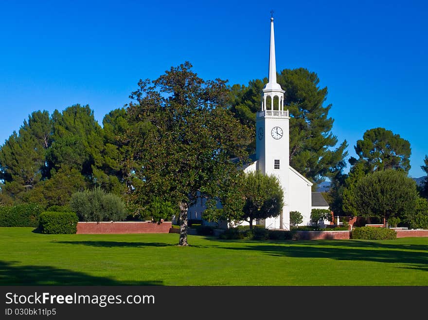 Small church with steeple in pastoral setting. Small church with steeple in pastoral setting.